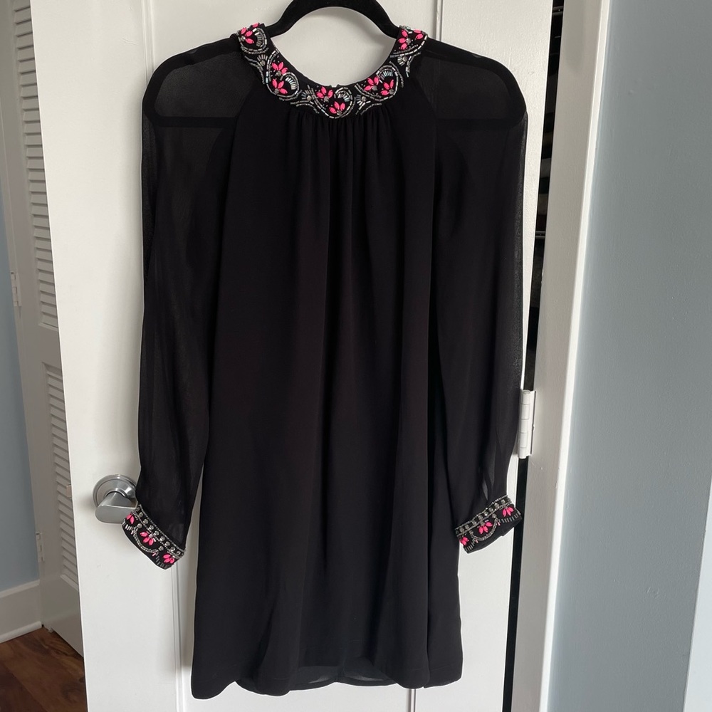 Black sheath dress with sheer long sleeves and beaded details